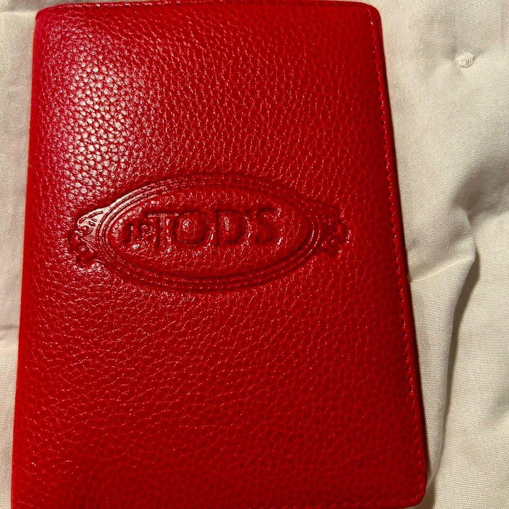 Red leather Tods wallet can be used for passport or just a wallet